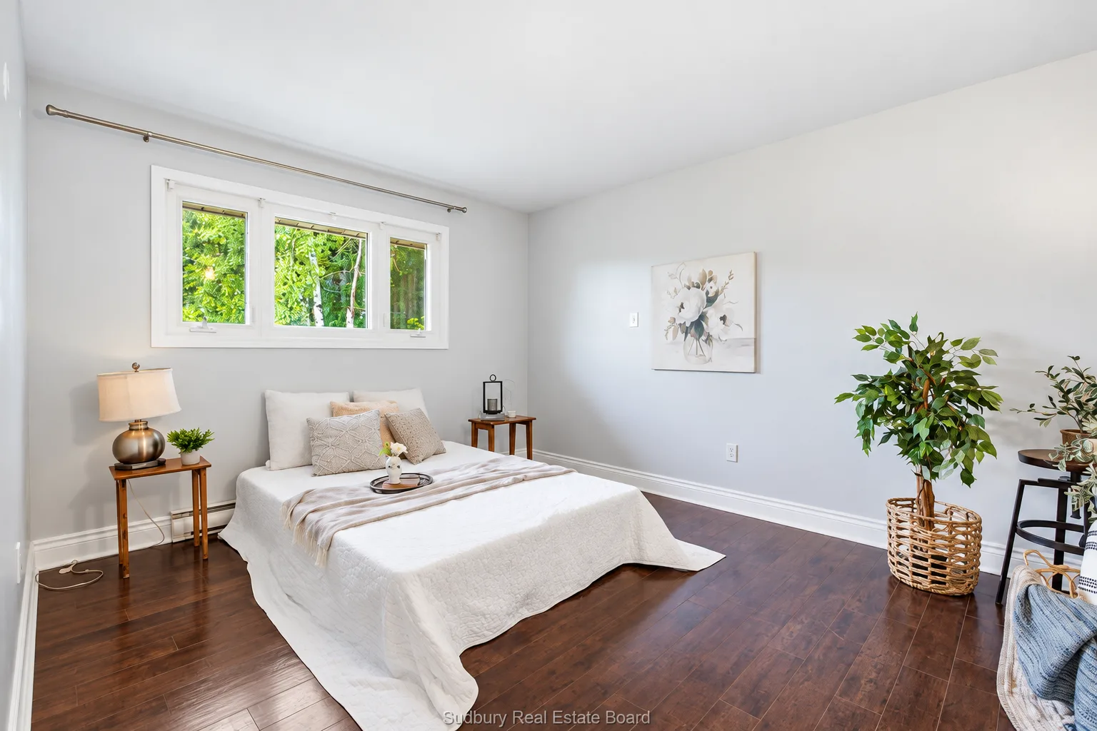 Main-floor apartment: primary bedroom with dark hardwood floors