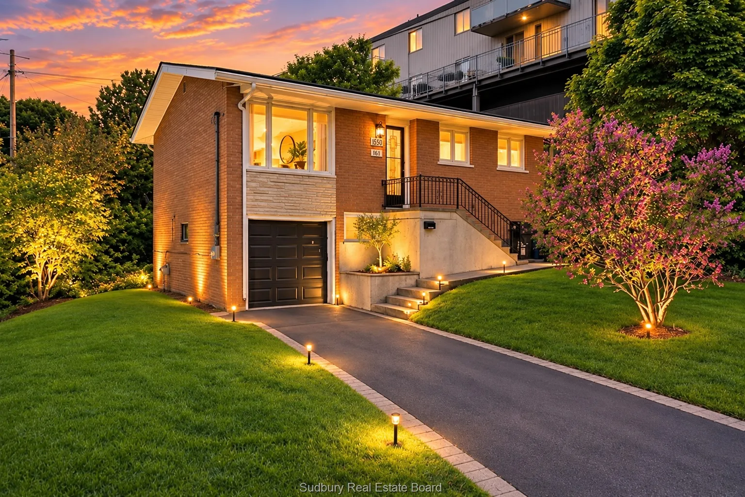 836 Prete Street at twilight: all-brick home with attached garage and driveway